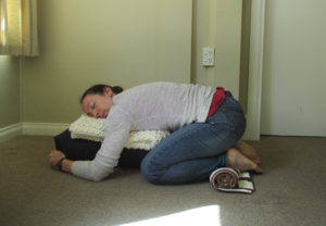 restorative child's pose with ankle support