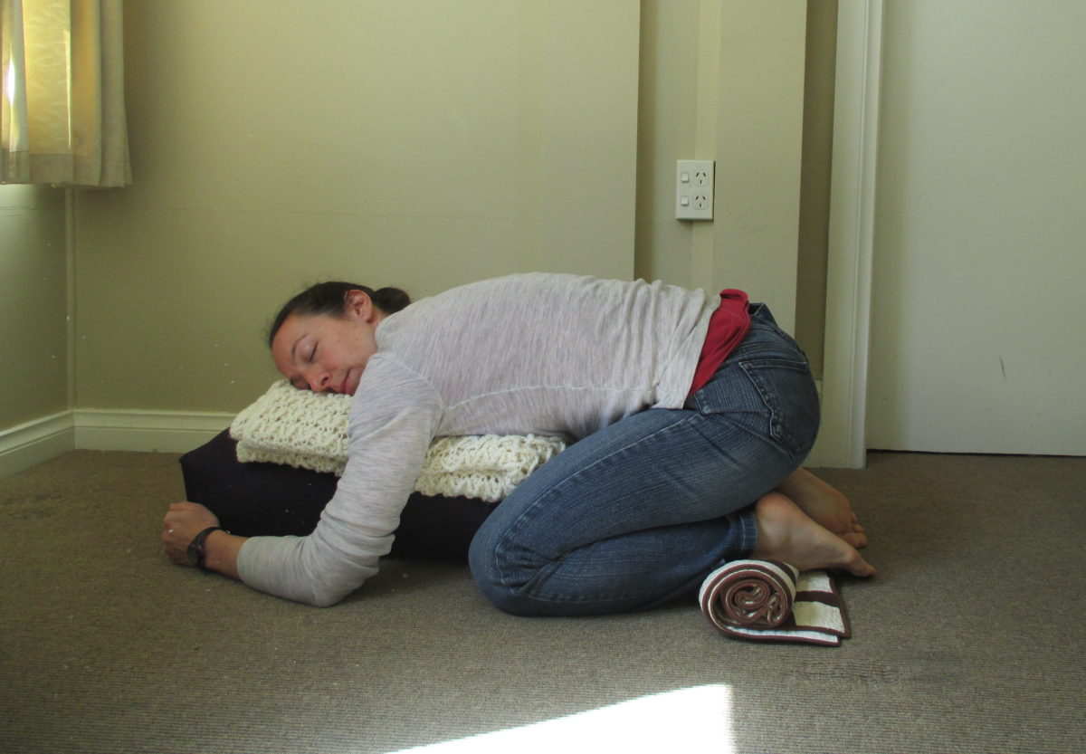 restorative child's pose with ankle support