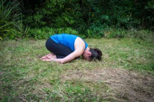 child's pose arms by side