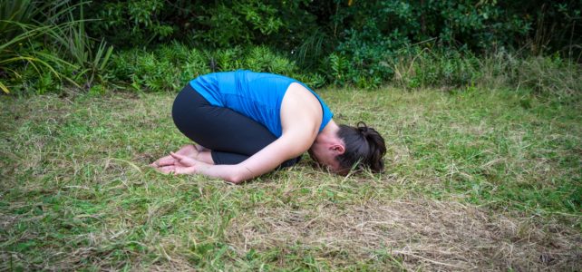 child's pose arms by side