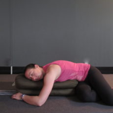 Supported restorative child’s pose with spinal twist