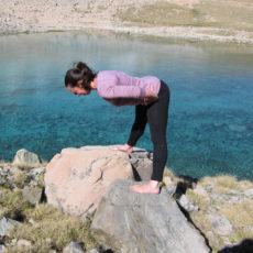 Stretching thighs and hamstrings with wide leg forward fold