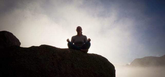 Megan Sety meditating in the mountains