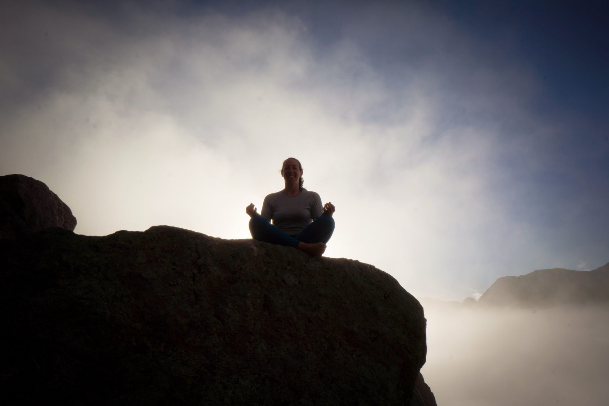 Megan Sety meditating in the mountains