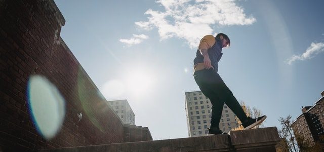 man balancing on the edge of a concrete walkway