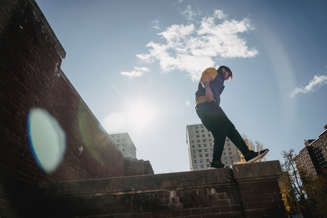 man balancing on the edge of a concrete walkway