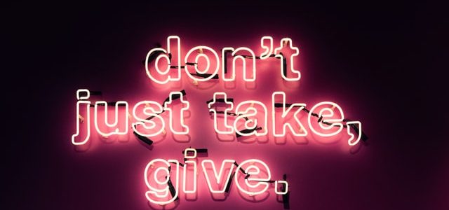 neon sign that says don't just take, give