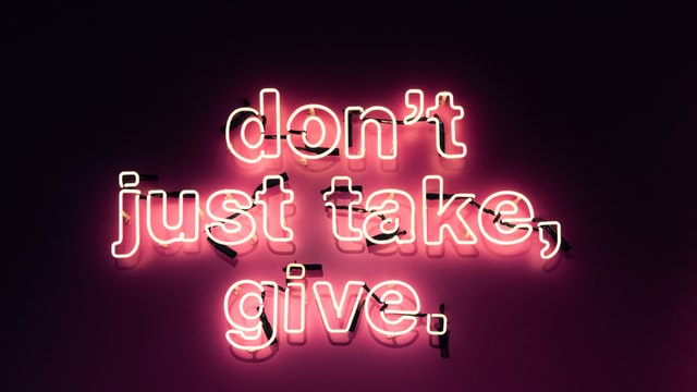 neon sign that says don't just take, give