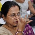 a woman with her fingers on her nose doing alternate nostril breathing