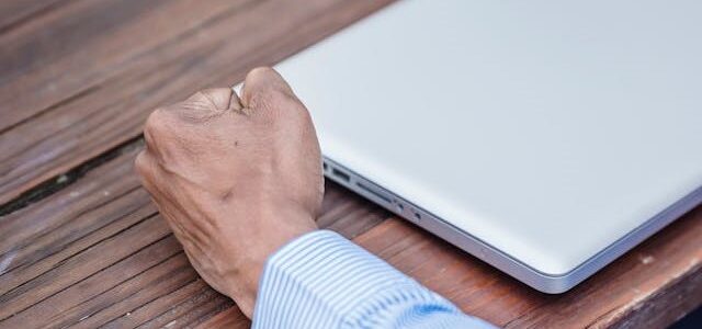 photo of person clenching their hand in a fist on a desk